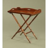 A 19th century mahogany butlers tray with stand, tray 77 cm x 49 cm.