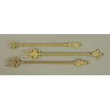 Three vintage brass toasting forks, Prince of Wales plume, imp and cat. Each length +/- 46 cm.