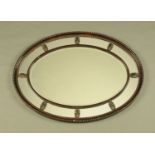 A George III style oval mirror,