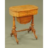 A Victorian walnut writing table, of shaped outline, the top opening to a writing surface,