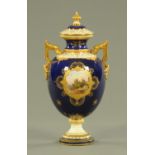 A Coalport vase, with blue ground, decorated with a castle panel and heightened with gilding.