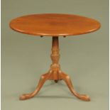 A George III mahogany tripod table, circular, with one piece top,