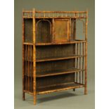 A Victorian bamboo cabinet, with single cupboard and series of shelves.