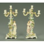 A pair of Sitzendorf porcelain four branch figural floral encrusted candelabra. Height 46 cm.