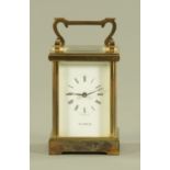 An English brass carriage clock timepiece, the enamel dial with Roman numerals inscribed H Samuel.