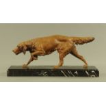 A painted spelter figure of a hunting dog, in pointing pose and mounted on a marble plinth.