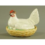 A 19th century Staffordshire hen on nest egg cruet, pale yellow base, red comb, brown head.