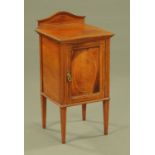An Edwardian inlaid mahogany bedside cabinet, with serpentine rear upstand,