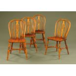 A set of four ash and elm single Windsor chairs, each with wheel back and crinoline stretcher.