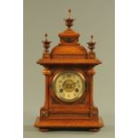 A late Victorian walnut cased mantle clock, with two train striking movement.