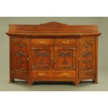 An Art Nouveau oak sideboard, with rear upstand and canted angles,