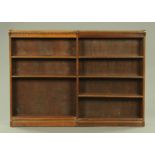 An Edwardian oak double open bookcase,