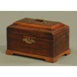 A George III mahogany tea caddy, with three interior compartments and raised on bracket feet.