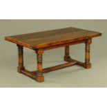 A large oak refectory style draw leaf dining table,