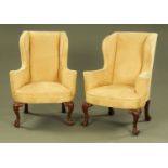 A pair of wing easy chairs in the Queen Anne style,