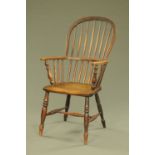 A 19th century Windsor armchair, with spindle back, solid seat and turned legs with stretchers.