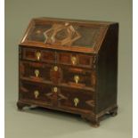 An antique oak bureau, with cushioned and moulded flap and drawer fronts and raised on bracket feet.