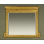 A gilt framed overmantle mirror, with bevelled glass and with moulded frame.