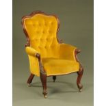 A Victorian mahogany framed gentleman's armchair, with deep buttoned back and stuffover seat,