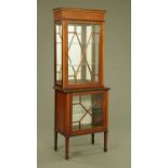 An Edwardian inlaid mahogany display cabinet, of narrow form with moulded cornice,