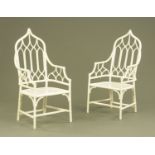 A pair of white painted armchairs, in the Gothic style.