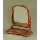 A Victorian mahogany framed toilet mirror, with serpentine base. Width 58 cm.