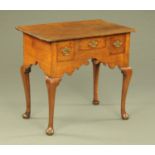 An 18th century oak lowboy,