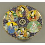 A cased Noritake plaque, decorated with figures. Diameter 45.5 cm.