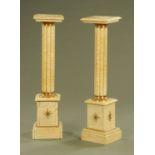 A pair of beige marble pedestals, each with metal embellishments. Height 108 cm.