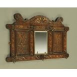 A late Victorian carved oak hall mirror and combined hat and coat hook. Width 92 cm.