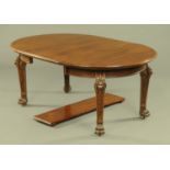 An Edwardian mahogany extending dining table, with two leaves,