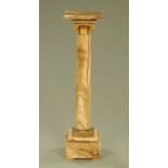 A Victorian variegated marble pedestal, with swivel top, brass capital and stepped base.