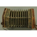 A late 19th century Continental accordion, with 21 brass tipped buttons (2 missing), 20 cm diameter.
