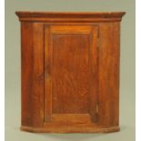 A 19th century oak hanging corner cupboard,