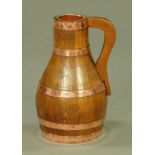 An oak and copper coopered Devon pitcher by J. H.