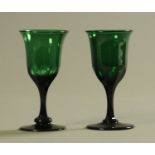 A pair of Georgian green wine glasses, each with faceted stem and circular foot. Height 14 cm.
