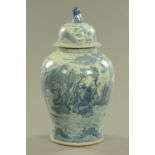 An Oriental lidded vase, blue and white decorated with figures in landscape.