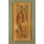 An Arts & Crafts carved walnut panel depicting fish. 74 cm x 35 cm.