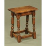 An oak joint stool, with four slightly angled turned legs and low stretchers. Width 45 cm.
