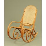 A bentwood rocking chair, with cane back and seat.