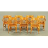 A set of seven oak armchairs, with solid seats and raised on cabriole legs.