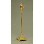 A brass Corinthian capital lamp standard, with square stepped base raised on paw feet.
