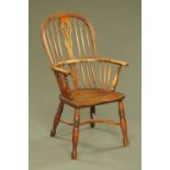 A 19th century ash and elm Windsor armchair, with splat back, solid seat and crinoline stretcher.