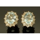 A pair of 18 ct white gold aquamarine and diamond cluster earrings, aquamarine +/- 4.