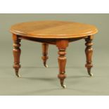 A Victorian mahogany dining table, circular when closed and with telescopic action (no leaves).