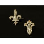 A French fleur de lis brooch, and Joan of Arc silver coloured pendant. Brooch width 30 mm.