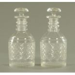 A pair of George III style cut glass decanters, with mushroom stoppers and faceted three ring neck,