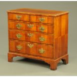 An antique walnut chest of drawers,