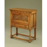 A carved oak fall front bureau,