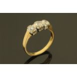 An 18 ct gold three stone diamond ring, .77 carats, size P.